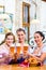 Group of people with wheat beer in Bavarian pub