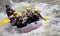 Group of people whitewater rafting