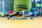 Group of people working out in a gym with a dumbbell