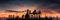 A group of people working on top of a house roof and placing tiles. Sunset backlight. People silhouettes