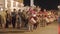 Group of performers in historical costumes walks in line