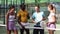 Group photo of positive people on padel tennis court