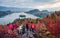 Group of photographers takes picture of Bled lake. Gloomy morning scene in Triglav National Park. Colorful autyumn scene of Julian