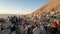 A group of photographers at the top of Nemrut Mountai near Commagene statue ruins waiting for sunset in Adiyaman, Turkey