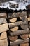 Group of piled firewood in winter with snow on top