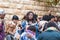 A group of pilgrims believers make a mass prayer near the outer walls of Dormition Abbey in old city of Jerusalem, Israel