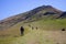 Group of pilgrims in Pyrenees mountains, France. Hiking in mountains. Napoleon route landscape. Tourists in Roncesvalles valley.