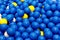 Group of plastic blue, yellow and white balls