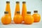 A group of plastic bottles of organic fresh orange juice