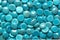 Group of polished turquoise glass pebbles, background.