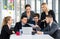 Group portrait of businesspeople team sitting in conference together in an office with intimate and excited the success on laptop