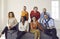 Group portrait of happy diverse business men and women on couch in new company office