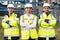 Group portrait of multiethnic industrial workers team consist of technicians, engineers, mechanic wearing helmet uniform