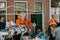 Group portrait of people in orange, crazy look, street activities for King`s Day festivity in the Netherlands