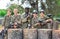 Group portrait of team of paintball players with marker guns