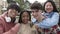 Group portrait of young multiracial students friends on school campus