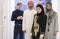 Group portrait of young Muslim people women in fashionable hijab dress with three Arabian men using smartphones at