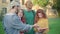 Group of positive groupmates explaining homework to charming redhead Caucasian woman. Four cheerful men and women