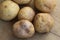 Group potato on wooden background