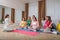 Group of pregnant women with men and doctor at courses for expectant parents indoors