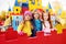 A group of preschoolers play and smile on the background of a children`s amusement Park