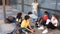 Group of preteen children in face masks resting outdoors in schoolyard during break in lessons. Back school concept