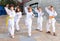 Group of preteen children learning karate movements in schoolyard