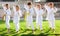 Group of preteen children practicing karate in summer park