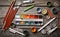 A group of products for drawing and creativity on a wooden table. Gouache, oil painting, watercolor paints, crayons, pencils.