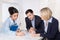 Group of a professional business team sitting at the table talking together.