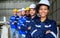 Group of professional engineers workers smiling to camera at factory