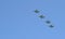 A group of professional pilots of military aircraft in sky.