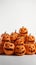 A group of pumpkins carved with various spooky faces, forming a ghostly congregation on a white background HD image