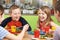 Group Of Pupils Sitting At Table In School Cafeteria Eating Meal