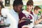 Group Of Pupils With Teacher Using Microscopes In Science Class