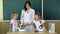 Group Of Pupils With Teacher Using Microscopes In Science Class. chalkboard on background, copy space. Back to school and home