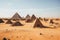 a group of pyramids in a desert