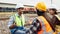 A group of railway engineers discussing work outdoors on the tracks