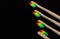 Group of rainbow eco bamboo toothbrushes, on black background.