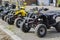 A group of random ATVs in a line outdoors