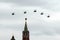 A group of reconnaissance and attack helicopters Ka-52 Alligator Hokum B fly in the sky over Red Square during an air parade ded