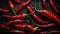 a group of red peppers sitting on top of a black table covered in water droplets and drops of water on top of the chili peppers