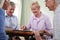 Group Of Retired Friends Playing Board Game At Social Club