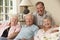 Group Of Retired Friends Sitting On Sofa At Home Together