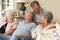 Group Of Retired Friends Sitting On Sofa At Home Together