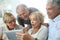 Group of retired people having fun using tablet