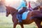 Group of rider girls riding their horses in park