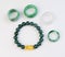 Group of ring and bracelet jade jewelry on white background