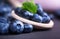 A group of ripe, juicy, organic blueberries with mint in a wooden spoon on a blurred purple background. Raw summer diet.