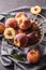 A group a ripe peaches in rustic bowl